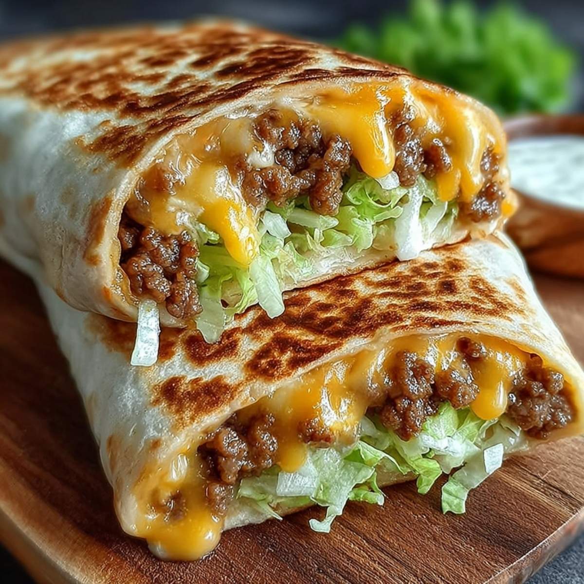 Homemade Big Mac Wraps on a wood board, showcasing the melty American cheese, savory ground beef, and crisp lettuce